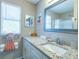 Bright bathroom featuring granite countertop, white vanity, and modern fixtures at 502 San Marino Dr, Lady Lake, FL 32159