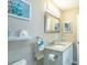 Cozy bathroom featuring granite countertop, white vanity, modern fixtures and teal starfish decor at 502 San Marino Dr, Lady Lake, FL 32159