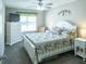 Cozy bedroom featuring floral bedding, white dresser, chair, and natural light from window at 502 San Marino Dr, Lady Lake, FL 32159