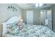 Comfortable bedroom with floral bedding, white furniture and carpeted floor at 502 San Marino Dr, Lady Lake, FL 32159