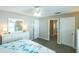 Neutral bedroom featuring white dresser with mirror, ceiling fan, and ensuite bathroom at 502 San Marino Dr, Lady Lake, FL 32159