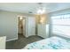 Bright bedroom featuring an ensuite bathroom, white dresser, and natural light from the window at 502 San Marino Dr, Lady Lake, FL 32159