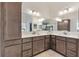 Bathroom with double sinks and plenty of cabinet storage at 5676 Patterson Loop, The Villages, FL 32163