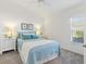 Comfortable guest bedroom with a queen-size bed and window at 5676 Patterson Loop, The Villages, FL 32163