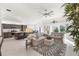 Spacious living room with beige couches and sliding glass doors at 5676 Patterson Loop, The Villages, FL 32163