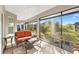 Relaxing screened porch with wicker furniture and view of backyard at 5676 Patterson Loop, The Villages, FL 32163