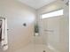 Spacious walk-in shower with glass enclosure and built-in seat at 5676 Patterson Loop, The Villages, FL 32163