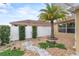 Landscaped backyard with gravel pathway, palm tree, and white fence at 583 Arruda Ter, The Villages, FL 32162