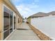 Backyard with access to the rear of the house through large sliding glass doors at 583 Arruda Ter, The Villages, FL 32162