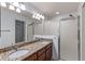 Double vanity bathroom with granite countertops and large shower at 583 Arruda Ter, The Villages, FL 32162