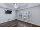 This bedroom has dark wood flooring and window shutters offering both beauty and privacy at 583 Arruda Ter, The Villages, FL 32162