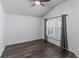 Bedroom with dark wood floors, ceiling fan and window with shutters at 583 Arruda Ter, The Villages, FL 32162