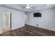 A cozy bedroom is complemented with dark wood floors and easy access to the en-suite bath at 583 Arruda Ter, The Villages, FL 32162