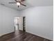 Bedroom with dark wood floors, open to living area, and built-in shelves at 583 Arruda Ter, The Villages, FL 32162