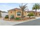 Tan house with a brown tile roof, landscaping, and a walkway at 583 Arruda Ter, The Villages, FL 32162