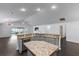 Large kitchen island with granite countertops and gray cabinets at 583 Arruda Ter, The Villages, FL 32162