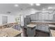 Kitchen features gray cabinets, breakfast bar, stainless appliances and wood-style floors at 583 Arruda Ter, The Villages, FL 32162