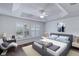 Comfortable main bedroom with a tray ceiling, ceiling fan, and large window at 583 Arruda Ter, The Villages, FL 32162