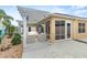 Outdoor patio with pergola, seating area, and lush landscaping at 583 Arruda Ter, The Villages, FL 32162