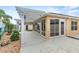 Enclosed patio area with ample sunlight, white pergola, and direct access to the home's interior at 583 Arruda Ter, The Villages, FL 32162