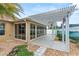 Covered patio with pergola, adjacent to a glass enclosure at 583 Arruda Ter, The Villages, FL 32162