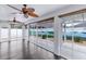 This glass enclosed sunroom features dark wood floors and natural light at 583 Arruda Ter, The Villages, FL 32162