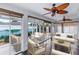 This bright sunroom has dark wood floors and natural light from the surrounding windows at 583 Arruda Ter, The Villages, FL 32162