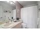 Clean bathroom with tub shower, sink, and toilet at 586 Juniper Way, Tavares, FL 32778