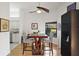 Dining room with wood table and chairs, and kitchen view at 586 Juniper Way, Tavares, FL 32778