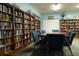 Community library with bookshelves, a large table, and comfortable seating at 586 Juniper Way, Tavares, FL 32778