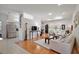 Open concept living room with hardwood floors and a view into the kitchen at 586 Juniper Way, Tavares, FL 32778