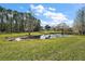 Serene pond view with lush greenery and tree at 586 Juniper Way, Tavares, FL 32778