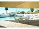 Inviting pool area with shaded seating and lounge chairs at 586 Juniper Way, Tavares, FL 32778