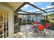 Relaxing screened patio with tiled floor, table, chairs, and fountain at 586 Juniper Way, Tavares, FL 32778