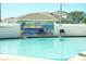 Refreshing swimming pool with a fun beach-themed mural at 586 Juniper Way, Tavares, FL 32778