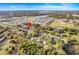 Aerial view of the neighborhood with a red pin on top of the house showing it's proximity to local amenities at 604 Palmetto Dr, Mascotte, FL 34753