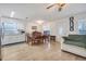 Bright dining area featuring stylish flooring and large windows with ample natural light at 604 Palmetto Dr, Mascotte, FL 34753