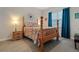 Charming bedroom with a wooden bed frame and colorful bedding at 729 Calabria Way, Howey In The Hills, FL 34737