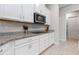 Modern kitchen features white cabinets and granite countertops at 729 Calabria Way, Howey In The Hills, FL 34737