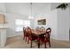 Bright dining room with wood table and chairs, and kitchen access at 7872 Niagara Falls Ct, Orlando, FL 32825