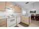 Open kitchen with a dining area and light wood cabinets at 7872 Niagara Falls Ct, Orlando, FL 32825