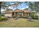 One-story house with a white garage door and well-maintained landscaping at 791 Princeton Dr, Clermont, FL 34711