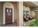 Front porch with red door, wicker chairs, and tile flooring at 791 Princeton Dr, Clermont, FL 34711