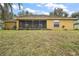 Rear view of house showing screened porch and yard at 791 Princeton Dr, Clermont, FL 34711