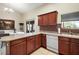 Kitchen boasts an island, dark wood cabinets, and access to a breakfast nook at 791 Princeton Dr, Clermont, FL 34711