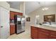 Kitchen with stainless steel refrigerator and island breakfast bar at 791 Princeton Dr, Clermont, FL 34711