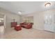 Living room with tile floor, brown couch, and wooden coffee table at 791 Princeton Dr, Clermont, FL 34711