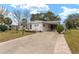 Single-wide manufactured home with carport and landscaped yard at 807 Maple Ln, The Villages, FL 32159