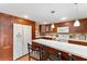 Modern kitchen with wood cabinets and white countertops at 807 Maple Ln, The Villages, FL 32159