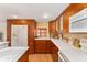 Modern kitchen with wood cabinets and white countertops at 807 Maple Ln, The Villages, FL 32159